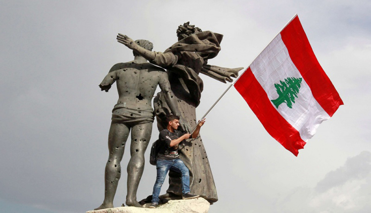 لبناني يرفع علم بلادهِ
